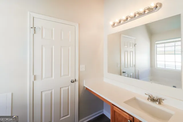 a bathroom with a sink and a mirror