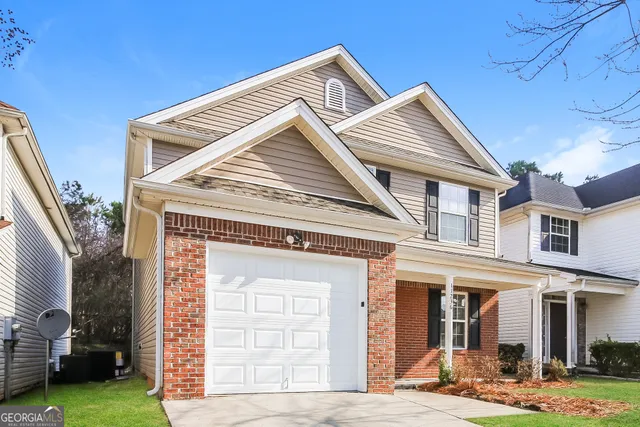 a front view of a house with garden