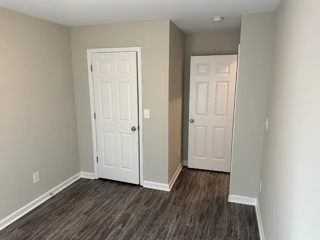 a view of a room with wooden floor and window