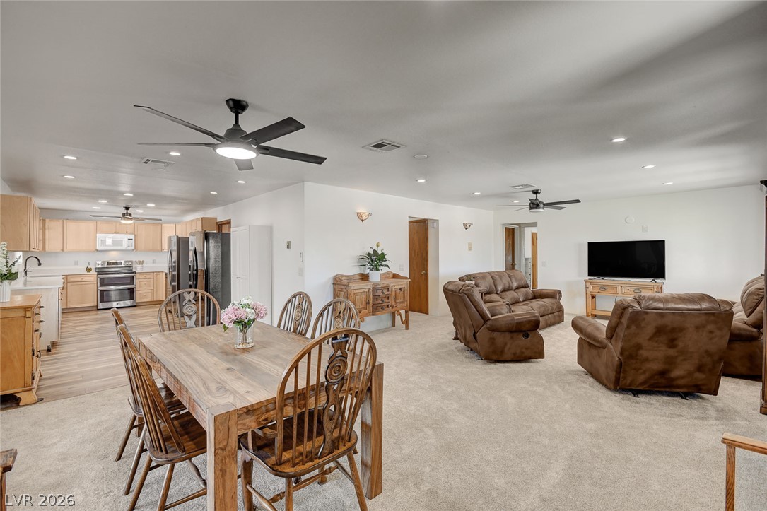 1920 Bowman Road Logandale, NV 89021 - Photo 5 of 68 An open layout connects the dining space directly to the living area and kitchen beyond.