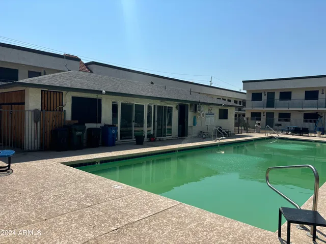 a view of a patio with a table and chairs
