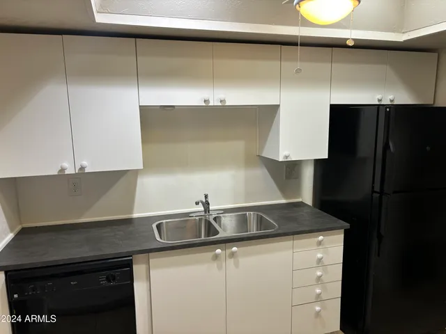 a kitchen with a sink and a refrigerator