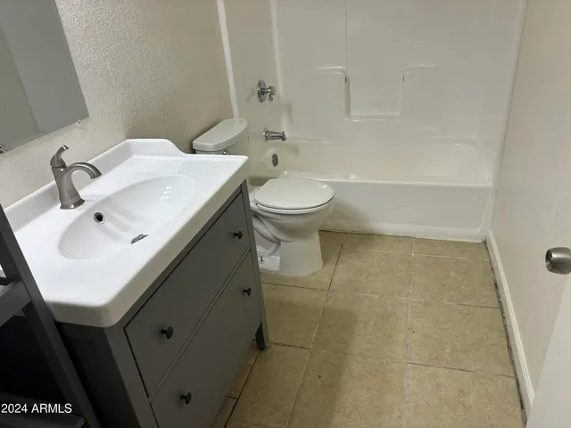 a bathroom with a sink toilet and a mirror