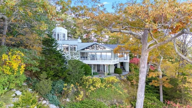 a front view of a house with a garden
