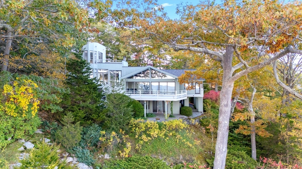 23 Ocean Street Manchester, MA 01944 - Photo 1 of 23 a front view of a house with a garden