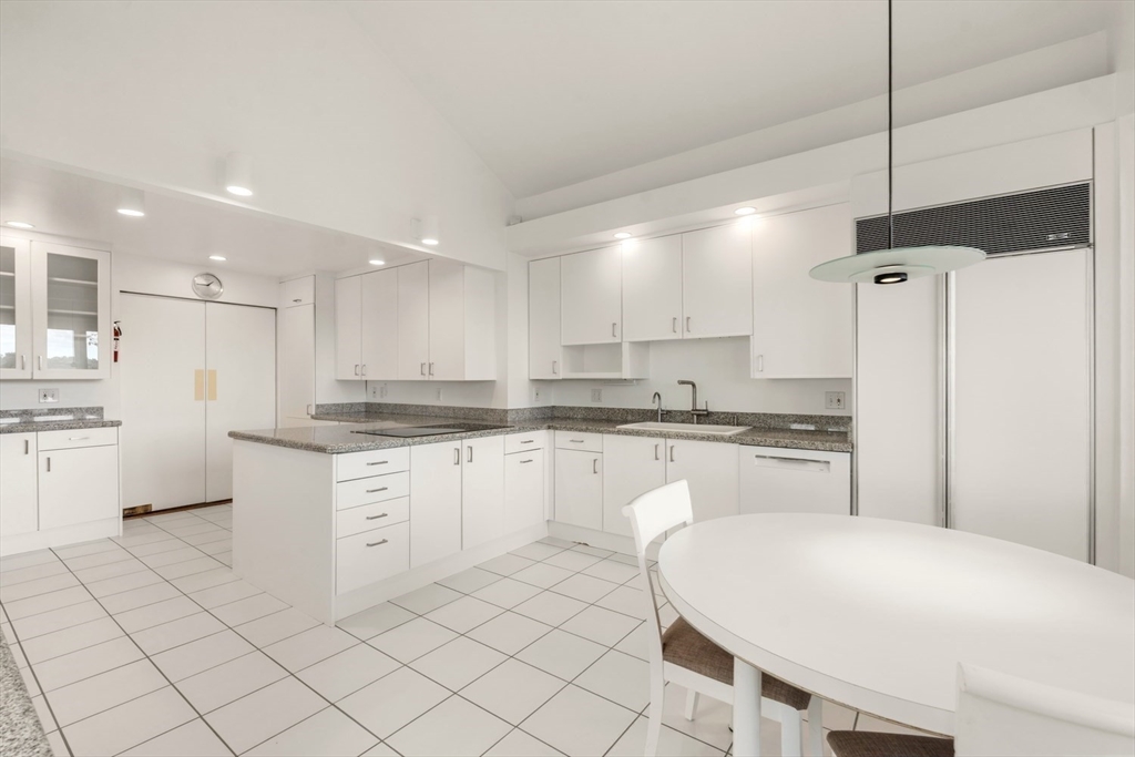 23 Ocean Street Manchester, MA 01944 - Photo 14 of 23 a kitchen with white cabinets and white appliances