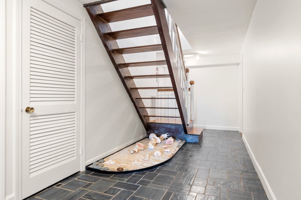 23 Ocean Street Manchester, MA 01944 - Photo 20 of 22 a view of entryway with wooden floor and stairs