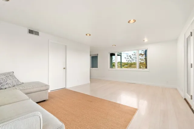 a view of entryway with wooden floor and stairs