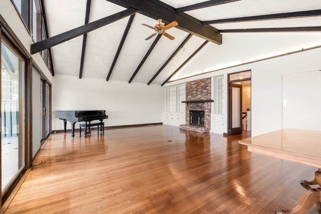 23 Ocean Street Manchester, MA 01944 - Photo 5 of 22 en empty room with wooden floor fireplace and windows