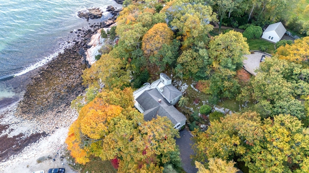 23 Ocean Street Manchester, MA 01944 - Photo 5 of 23 a aerial view of a house with swimming pool and large trees