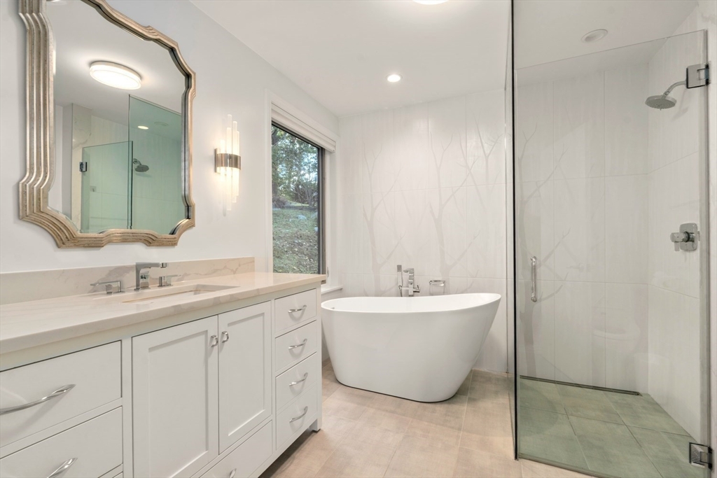 23 Ocean Street Manchester, MA 01944 - Photo 10 of 22 a bathroom with a double vanity sink mirror and bathtub