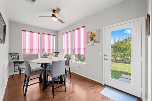 a view of a dining room with furniture window and wooden floor