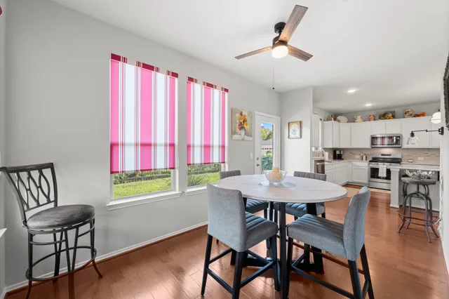 a view of a dining room with furniture and wooden floor