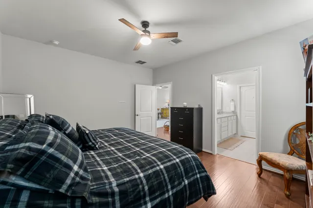 a bedroom with a bed and dresser