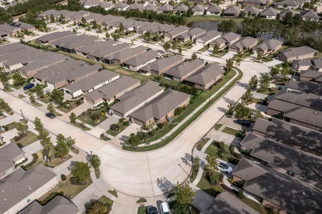 an aerial view of a residential houses with outdoor space