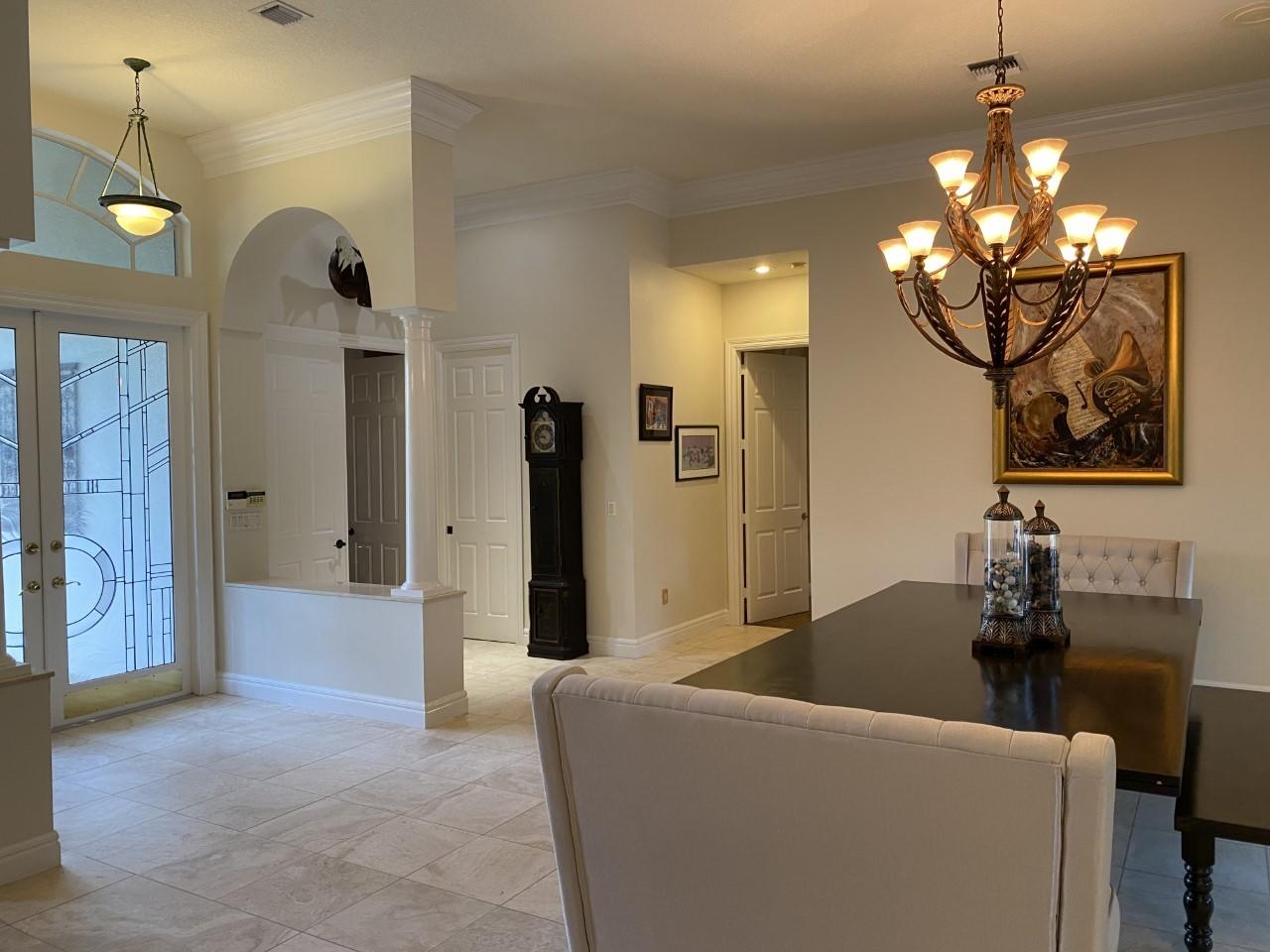 5900 Our Robbies Road Jupiter, FL 33458 - Photo 2 of 53 a living room with furniture and a chandelier