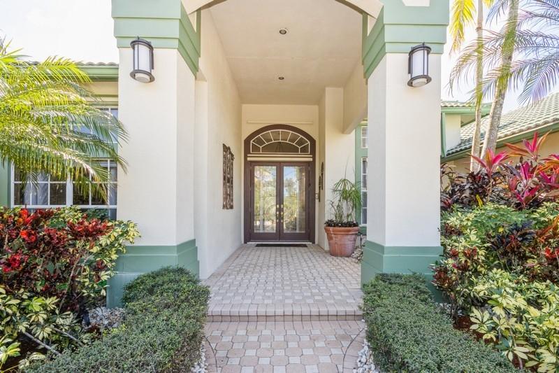 5900 Our Robbies Road Jupiter, FL 33458 - Photo 19 of 53 a front view of a house with a garden