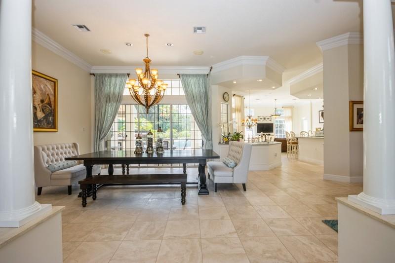 5900 Our Robbies Road Jupiter, FL 33458 - Photo 21 of 53 a living room filled with furniture and a chandelier