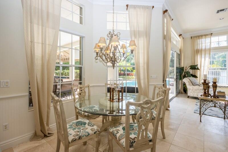 5900 Our Robbies Road Jupiter, FL 33458 - Photo 26 of 53 a view of a dining room with furniture and a chandelier