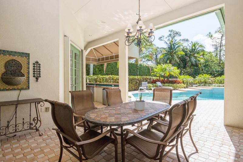 5900 Our Robbies Road Jupiter, FL 33458 - Photo 28 of 53 a view of a dining room with furniture wooden floor and chandelier
