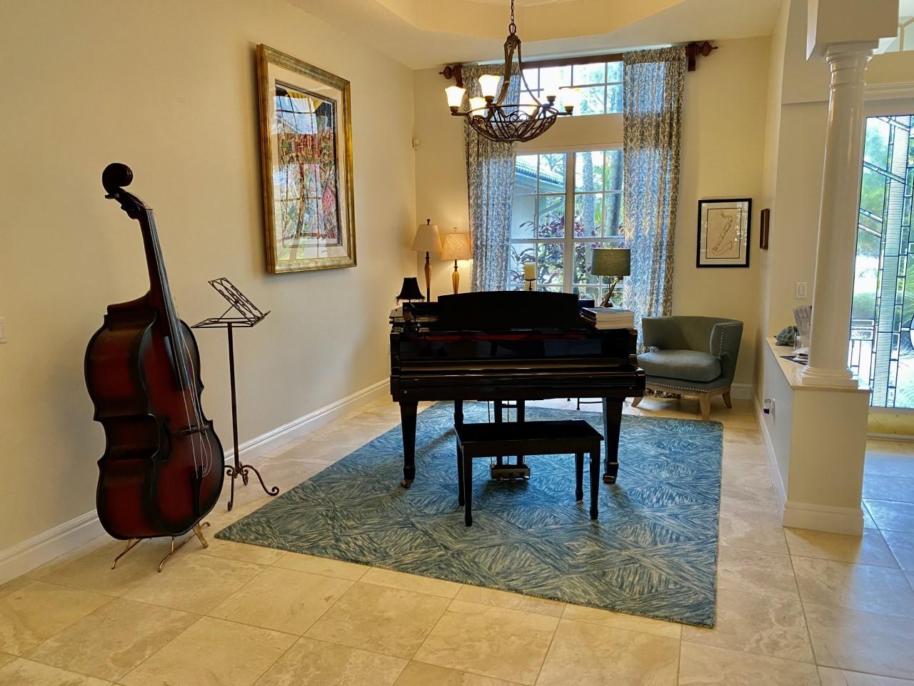 5900 Our Robbies Road Jupiter, FL 33458 - Photo 4 of 53 a living room with furniture and a chandelier
