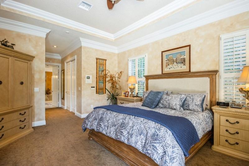 5900 Our Robbies Road Jupiter, FL 33458 - Photo 31 of 53 a bedroom with a large bed and a chandelier