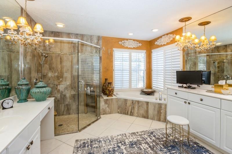 5900 Our Robbies Road Jupiter, FL 33458 - Photo 32 of 53 a bedroom with a bed and a flat screen tv