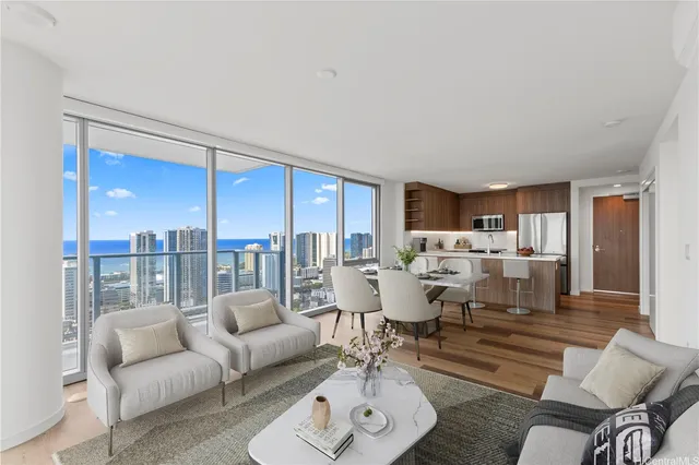 a living room with furniture wooden floor and a large window