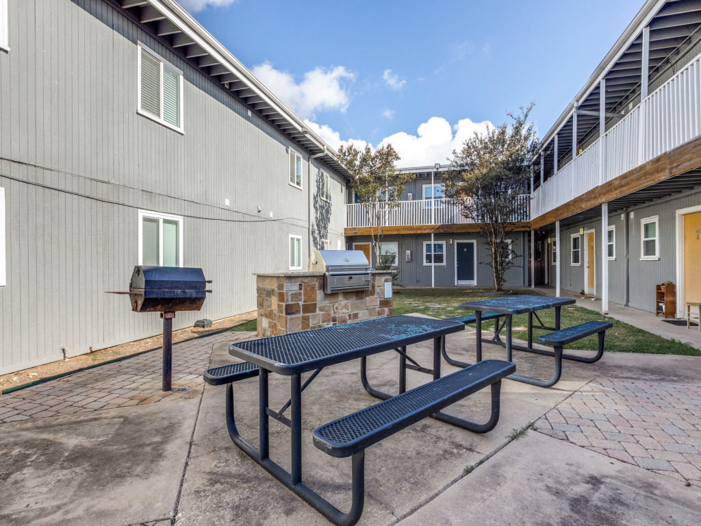 2401 Manor Road, Unit 218 Austin, TX 78722 - Photo 10 of 27 An inviting courtyard features picnic tables, an outdoor grill, and easy access to residences.