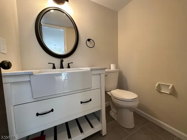a bathroom with a toilet a sink and a mirror