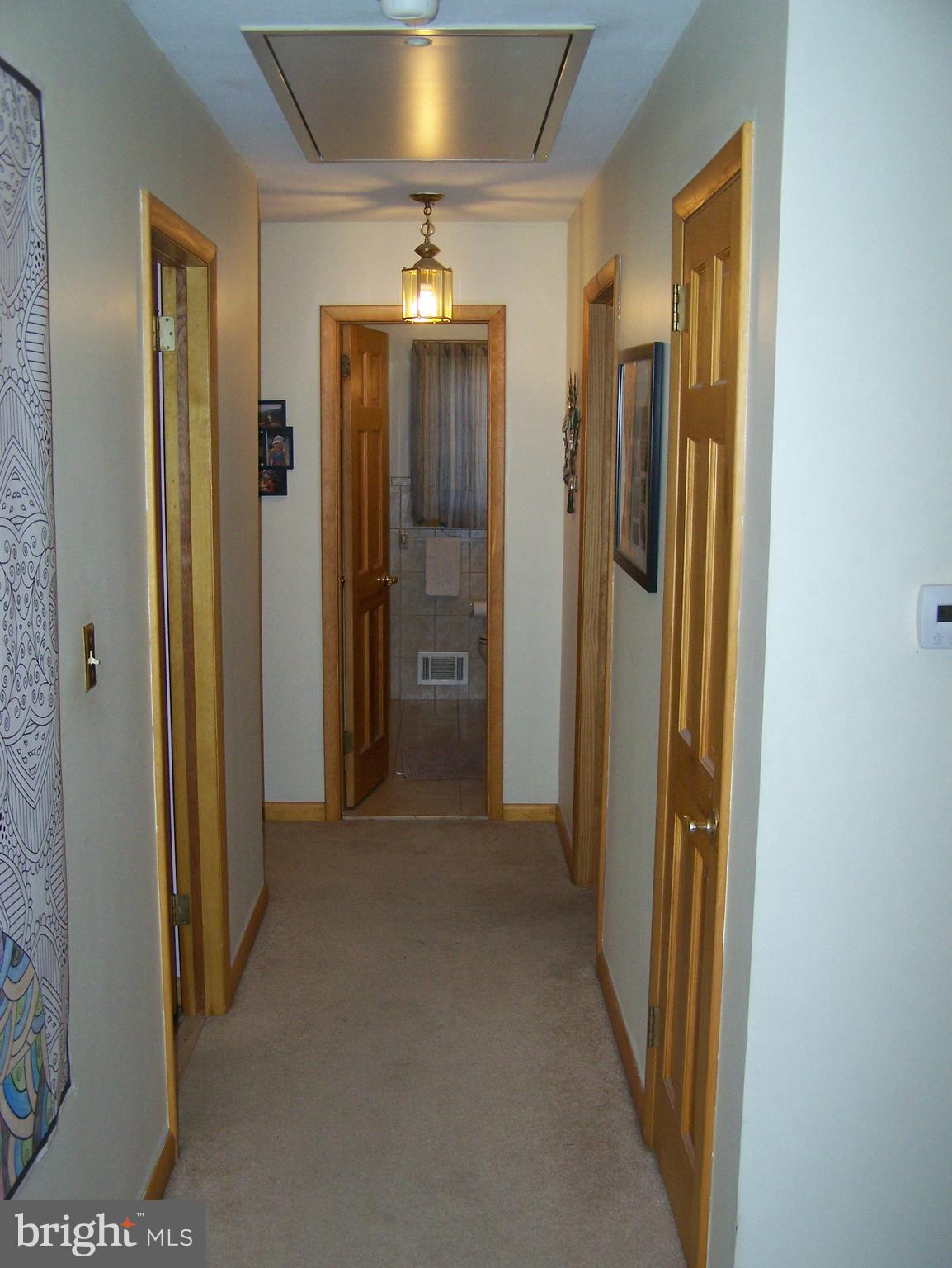 215 Windsor Road Robbinsville, NJ 08691 - Photo 17 of 34 a view of a hallway with wooden shelves