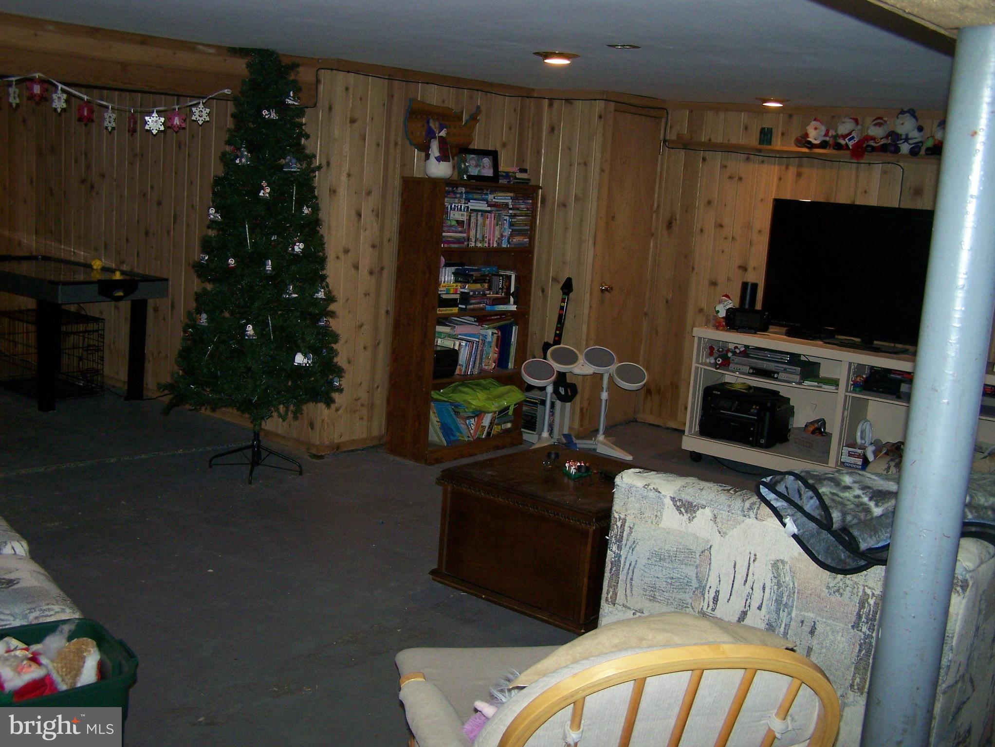 215 Windsor Road Robbinsville, NJ 08691 - Photo 20 of 34 a bedroom with a bed a flat screen tv and a bookshelf