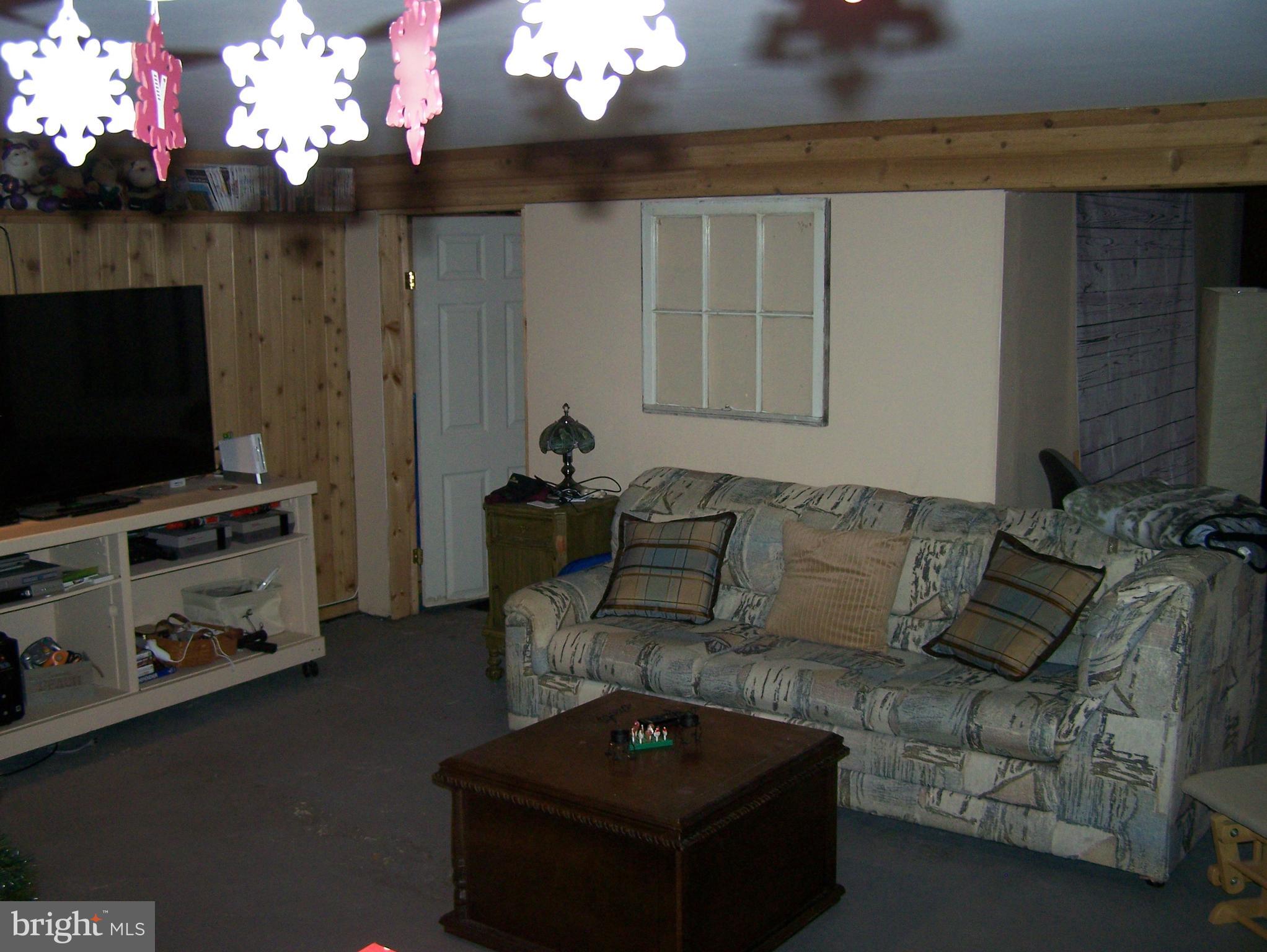215 Windsor Road Robbinsville, NJ 08691 - Photo 21 of 34 a living room with furniture a flat screen tv and a fireplace