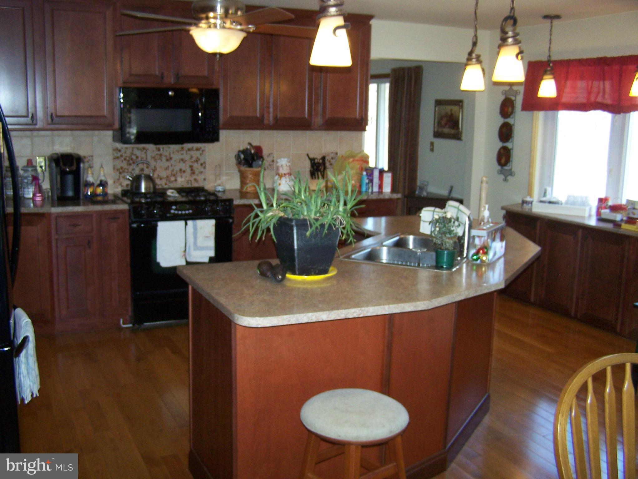 215 Windsor Road Robbinsville, NJ 08691 - Photo 4 of 34 a kitchen with a sink cabinets and wooden floor