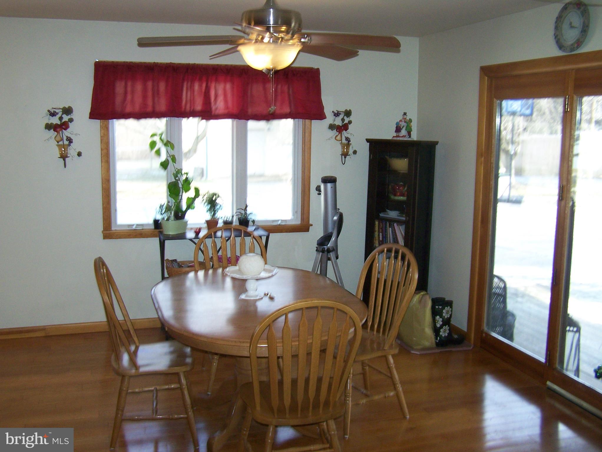 215 Windsor Road Robbinsville, NJ 08691 - Photo 8 of 34 a view of a dining room with furniture a chandelier and wooden floor