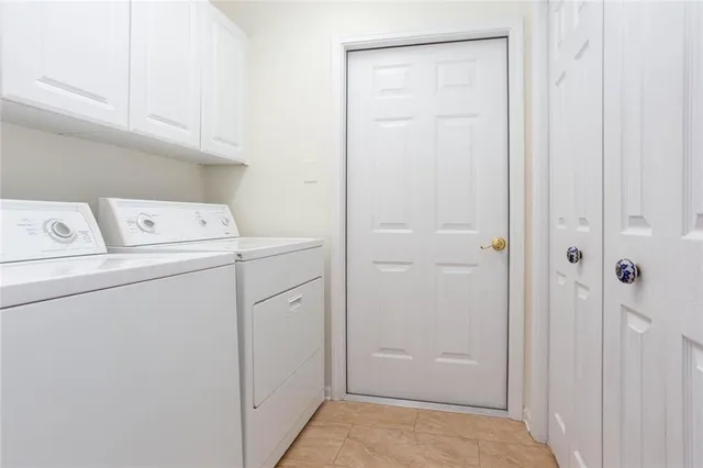 a bedroom with a bed a window and a chandelier