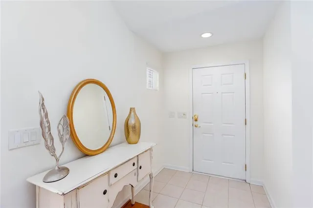 a living room with furniture a fireplace and kitchen view