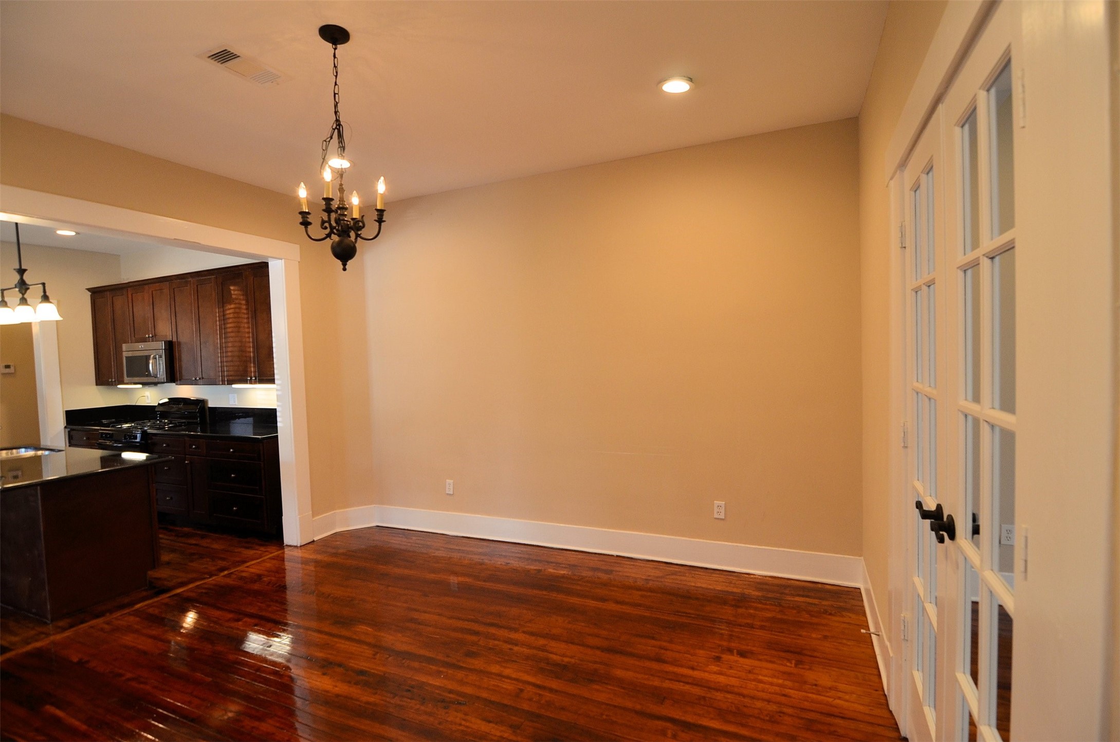 1602 Lee Street Houston, TX 77026 - Photo 13 of 26 a view of a kitchen with a sink a refrigerator and wooden floor