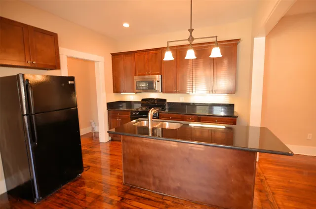 a kitchen with a refrigerator a sink and a stove
