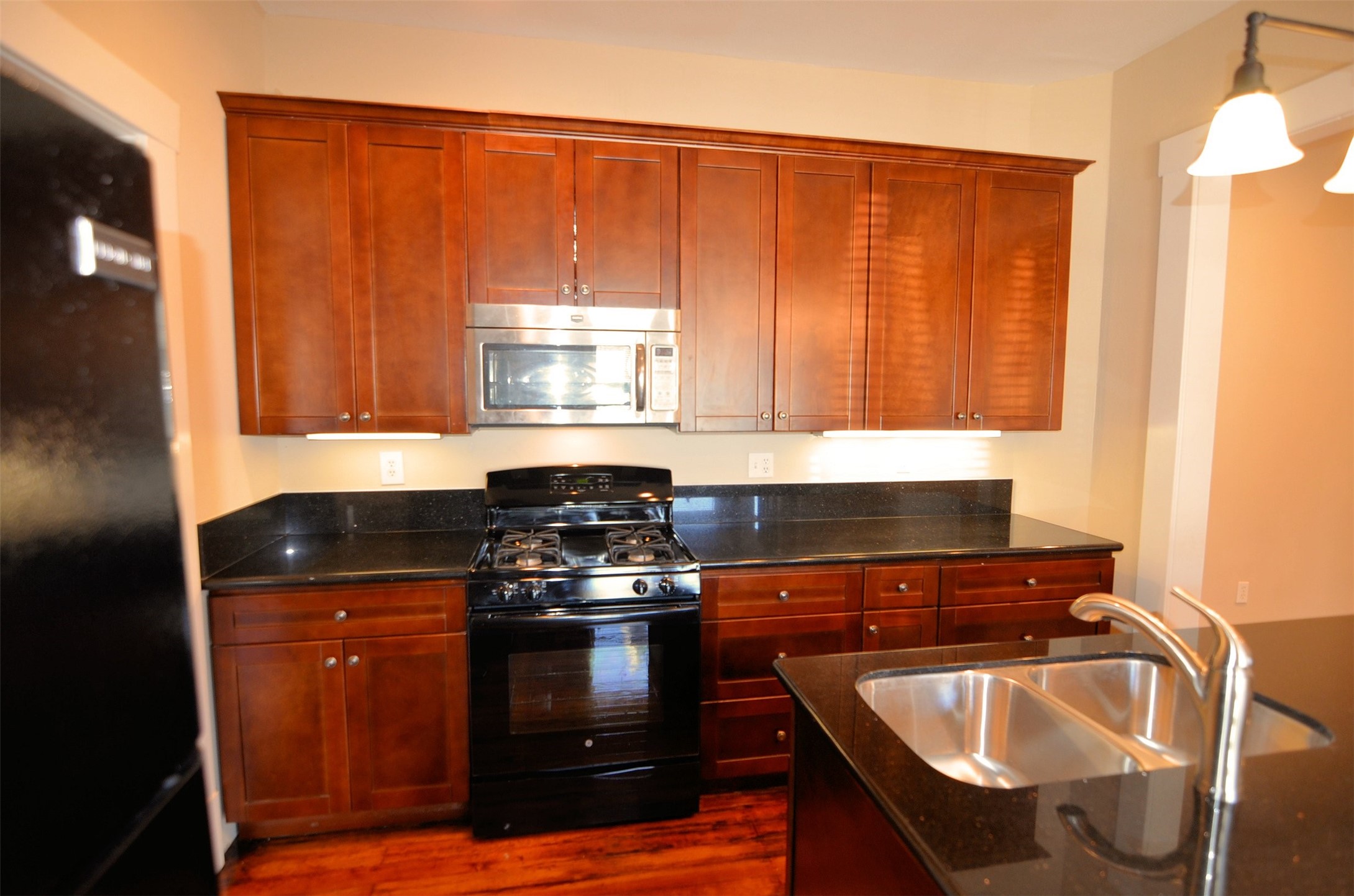 1602 Lee Street Houston, TX 77026 - Photo 17 of 26 a kitchen with granite countertop a sink stove and cabinets