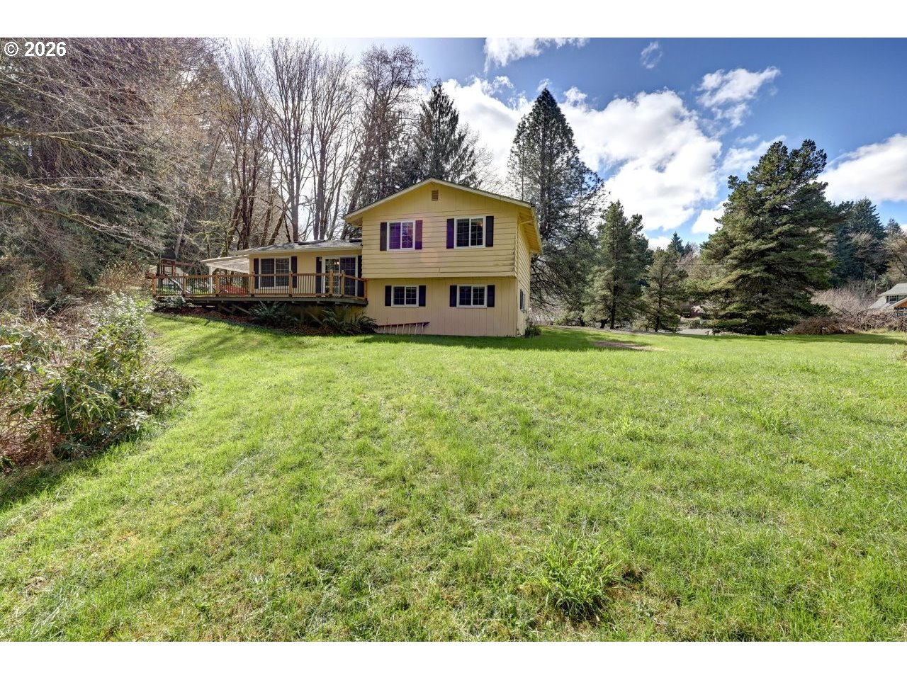 90835 McLean Hill Road Clatskanie, OR 97016 - Photo 20 of 22 a view of a big house with a big yard and large trees