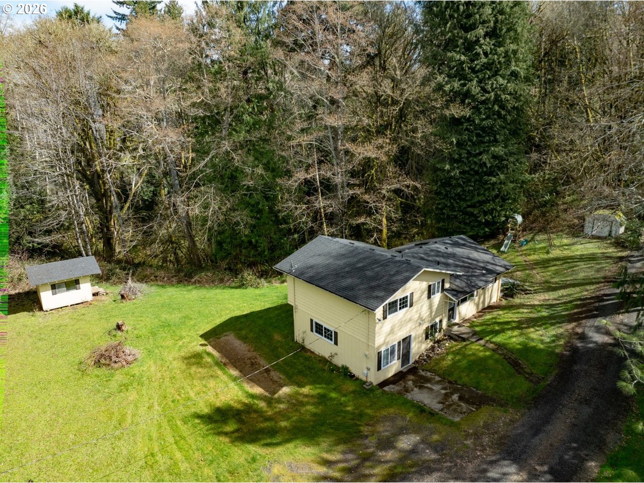 90835 McLean Hill Road Clatskanie, OR 97016 - Photo 21 of 22 a backyard of a house with table and chairs