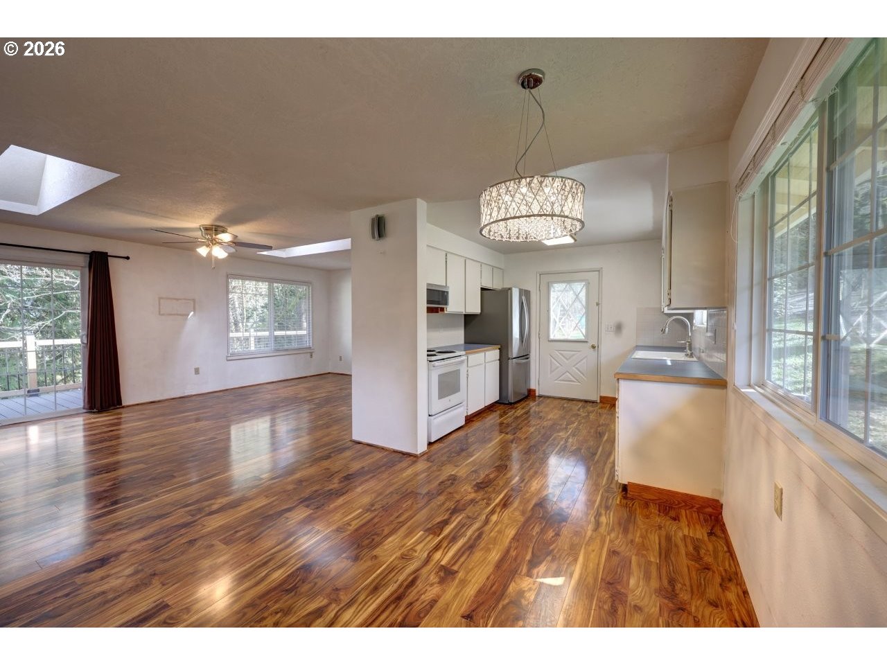 90835 McLean Hill Road Clatskanie, OR 97016 - Photo 5 of 22 a view of a big room with wooden floor and windows