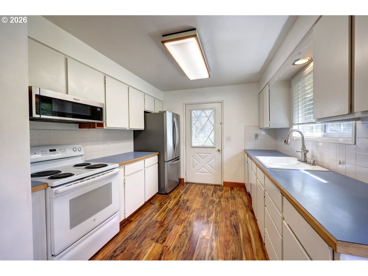 90835 McLean Hill Road Clatskanie, OR 97016 - Photo 6 of 22 a kitchen with a sink stove and microwave
