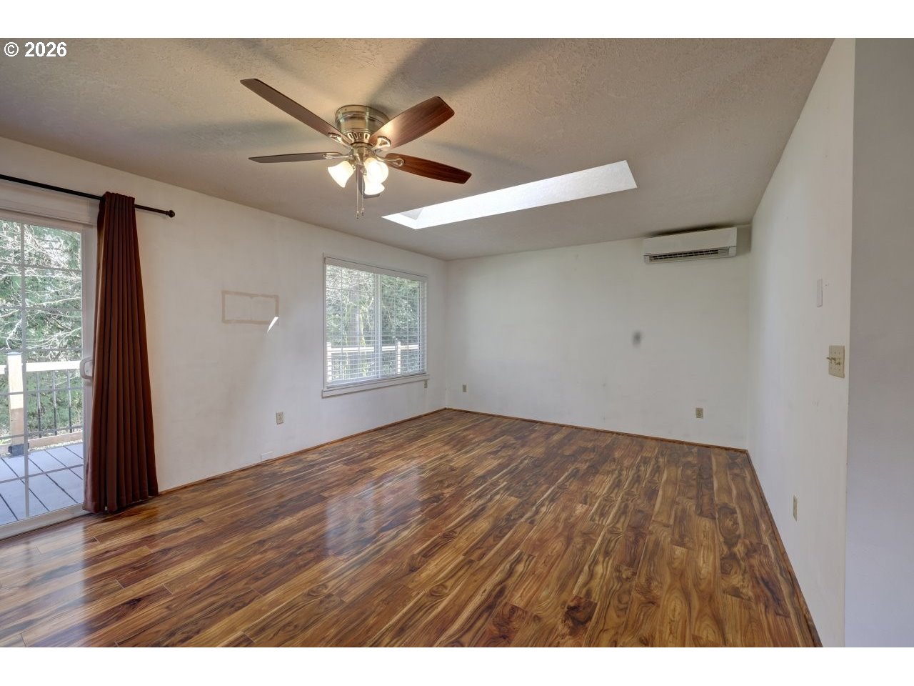 90835 McLean Hill Road Clatskanie, OR 97016 - Photo 7 of 22 a view of an empty room with wooden floor and a window