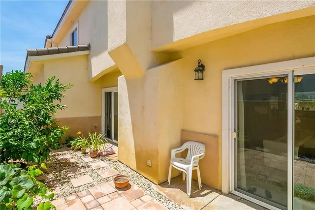 a view of a chair and tables in the balcony