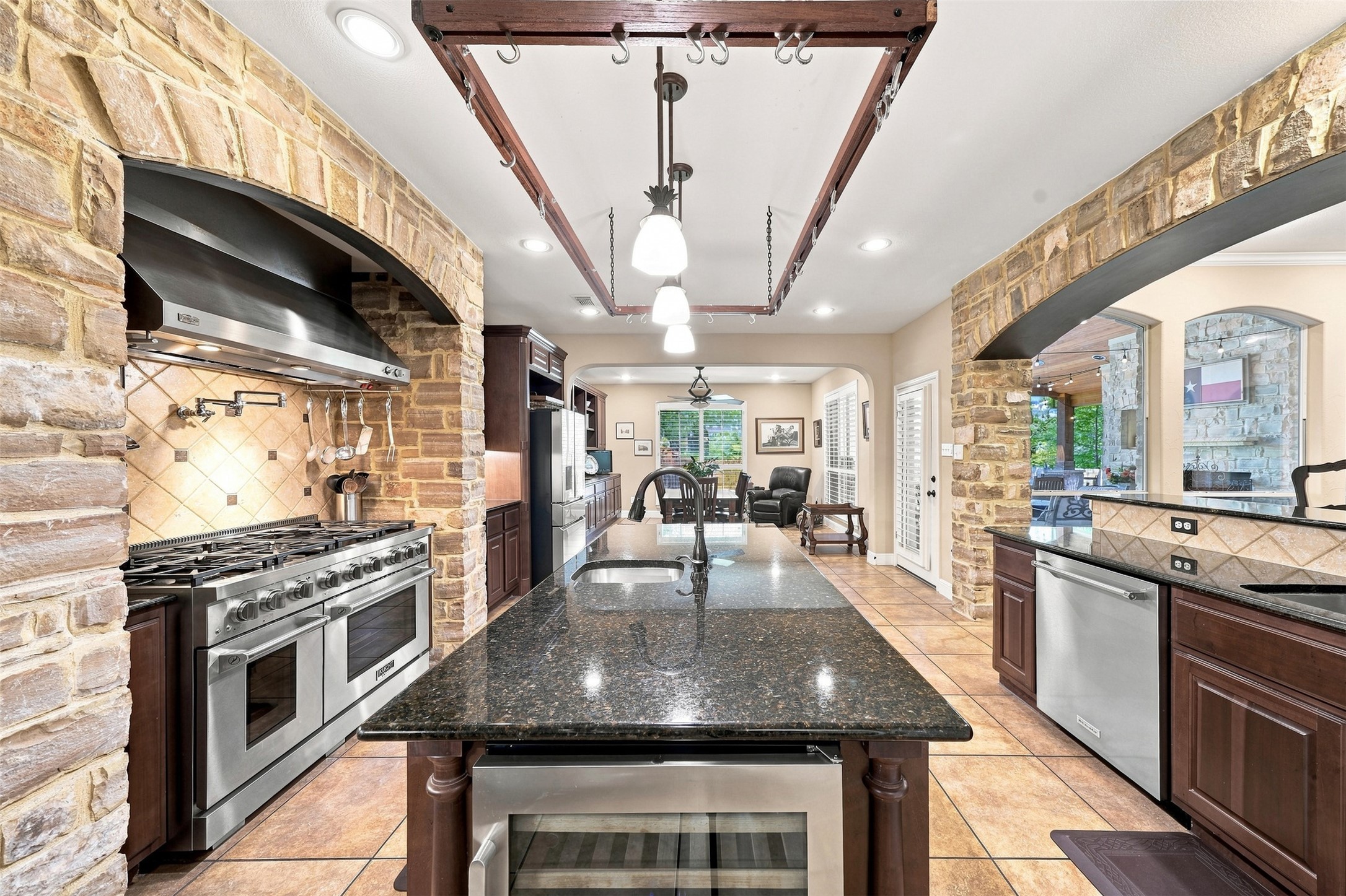 402 Ridgetop Bend Cedar Park, TX 78613 - Photo 17 of 40 Stone archways and a large granite island frame this gourmet kitchen design.