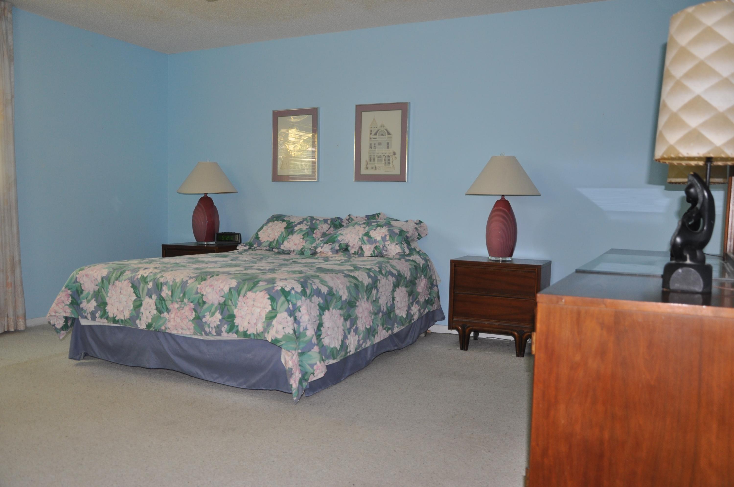 22615 Southwest 56th Avenue Boca Raton, FL 33433 - Photo 8 of 14 a bedroom with a bed and a potted plant on dresser