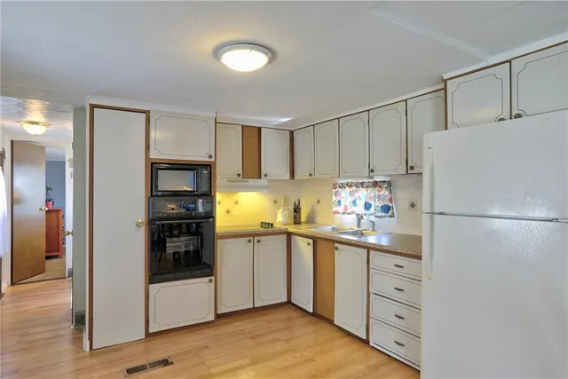 a kitchen with stainless steel appliances a refrigerator sink and cabinets