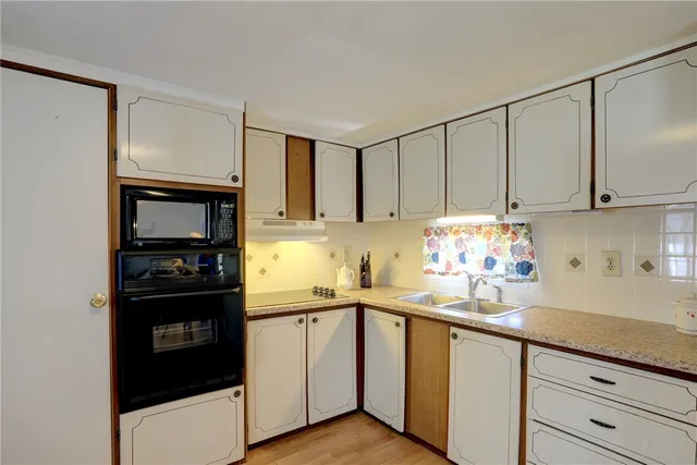 a kitchen with stainless steel appliances a sink cabinets and a counter top space